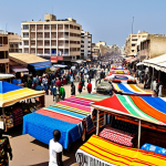 Dakar Cityscape & Local Market**

A vibrant street scene in Dakar, Senegal showcasing a bustling local market. Vendors display colorful textiles, spices, and crafts. Locals in modest, everyday clothing interact and shop. In the background, the modern cityscape of Dakar rises. The scene captures the energy and cultural richness of the city. Safe for work, appropriate content, fully clothed, family-friendly, professional photography, perfect anatomy, correct proportions, natural pose, well-formed hands, proper finger count.